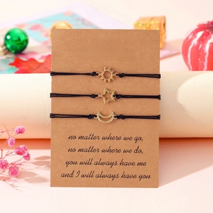 Three-piece sun moon and star friendship bracelets on a gift card with black cords