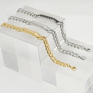 Cuban chain bracelets in gold and silver steel on acrylic stands for couples