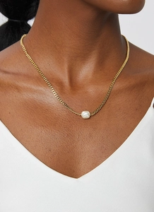Fashionable golden Cuban chain necklace with a white square freshwater pearl pendant on a model