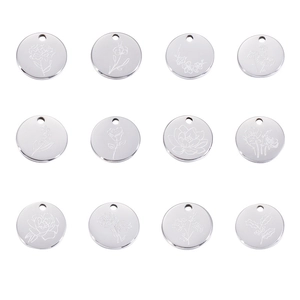 Detailed macro shot of twelve stainless steel round pendants with floral engravings