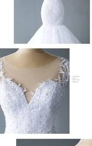 Detail of bridal dress with delicate lace floral embroidery, sequins and V-neck mesh design
