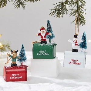 Three metal Christmas mailbox ornaments with reindeer, Santa, and snowman on snowy base