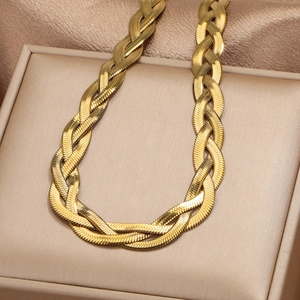 Macro detail of golden double-layered snake chain and woven texture on satin fabric