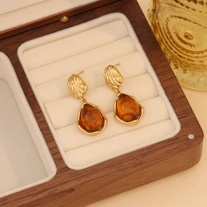 Vintage amber style teardrop earrings with gold textured studs in a wooden jewelry box