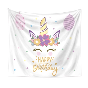 Detailed close-up of unicorn theme happy birthday wall tapestry with macaron floral patterns