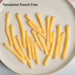 Realistic PVC french fries keychain pendants with metal rings on white ceramic plate