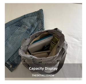 Interior view of grey quilted tote bag with bow embroidery showing large storage capacity
