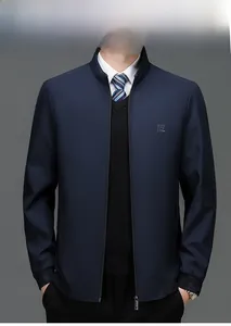 Detailed close-up of a royal blue men's jacket with standing collar and metal zipper