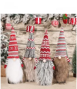 Detail of Christmas gnome bottle covers with knitted Nordic patterns and faux fur beards
