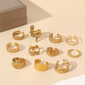 11-piece vintage 18k gold plated ring set with heart and leaf motifs on beige background