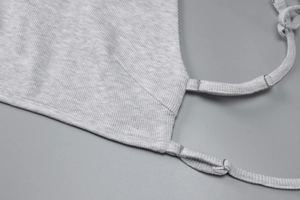 Close-up of gray ribbed knit fabric texture with adjustable silver metal strap buckle