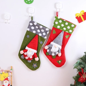 Detailed view of red and green Christmas stockings with 3D Santa gnome plush figures