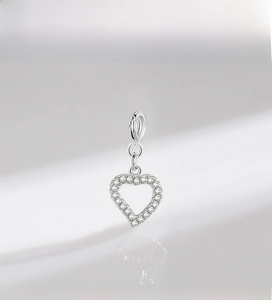 Macro shot of s925 silver heart pendant with pavé cubic zirconia and spring clasp