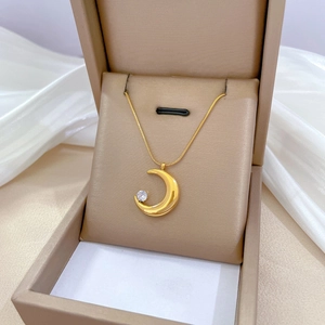 Gold titanium moon pendant necklace with zircon on a sleek snake chain in a gift box
