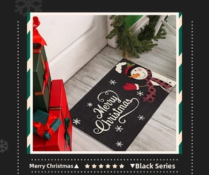 Detail of Christmas doormat with snowman pattern and Merry Christmas text on wooden floor