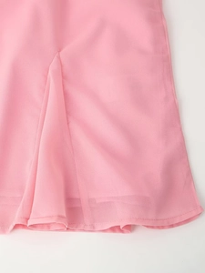 Detail of pink bohemian chiffon blouse showing ruffled layered hem and soft fabric texture