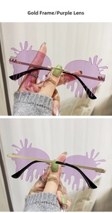 Detail view of gold frame and purple gradient teardrop lenses on rimless sunglasses
