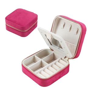 Detail view of pink velvet jewelry box with mirror, ring slots and necklace hooks