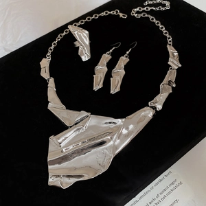 Detailed set of silver irregular geometric crumpled metal necklace, earrings and ring