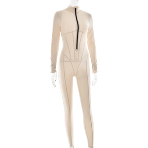 Detail showing the black front zipper and stretch seams of a beige long-sleeve bodysuit