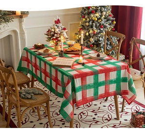 Detailed view of red and green plaid Christmas tablecloth in a festive dining setting