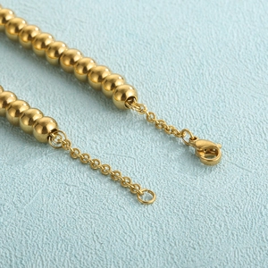Titanium steel beaded bracelet in gold with lobster clasp and adjustable extension chain