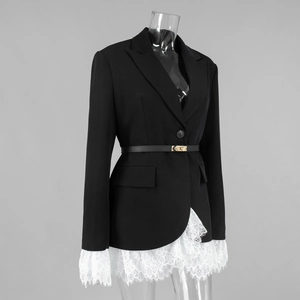 Detailed view of women's black blazer with white lace trim and gold buckle leather belt