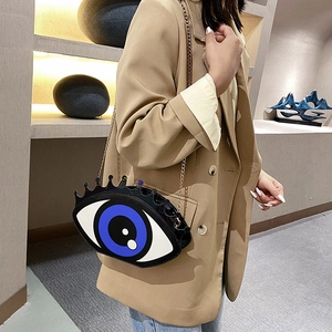 Creative evil eye chain crossbody bag featuring vibrant blue eye and colorful bead decor