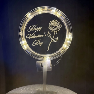 Detail of LED light-up acrylic cake topper with Happy Valentine's Day engraving and roses