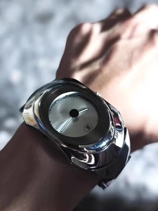 Close-up of Y2K silver irregular quartz watch with minimalist dial and calendar window