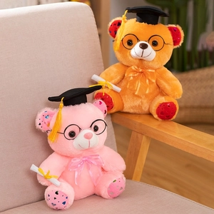 Detail of cute graduation bears with doctor hats and heart sequin details on paws