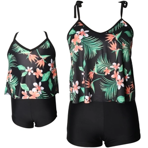 Detail of two-piece swimsuit with tropical floral tankini top and black bottoms