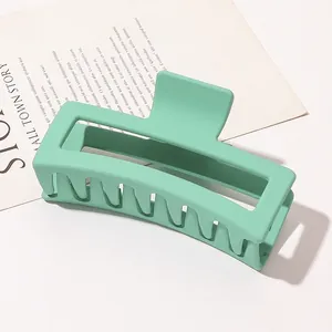 Detail of matte mint green hollow hair claw clip with strong spring and multi-tooth design