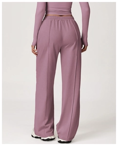 Rear view of high-waisted loose sports pants in soft grey-purple jersey knit fabric