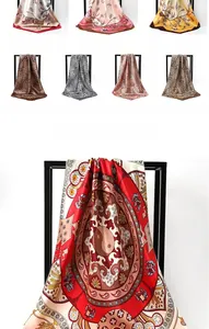 Detail of silk-satin square scarves with floral and leopard prints displayed on a rack