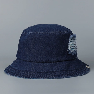 Detailed view of distressed denim bucket hat featuring frayed edges and vintage textures