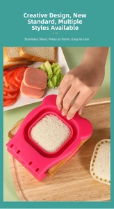 Macro shot of hand using the stainless steel sandwich cutter to seal pink animal shapes