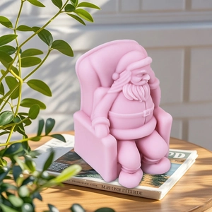 Pink silicone mold of Santa Claus in armchair for DIY candles and Christmas decor