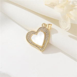 Golden heart pendant with white mother-of-pearl and crystal pavé on silk background