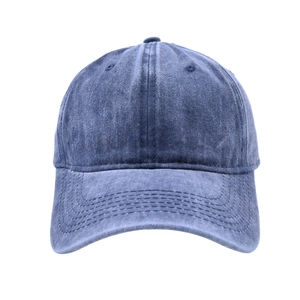 Macro shot of washed denim cotton texture and stitching on the baseball cap