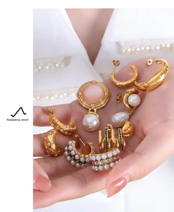 Detail of vintage gold stainless steel earrings with pearls and pink gemstones