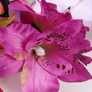 Macro detail of artificial silk cymbidium orchid hair clip with dark pink spotted petals