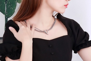 Close-up of double-layer silver chain necklace with heart pendant and OT toggle clasp