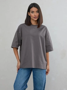 T-shirt larga in cotone grigio scuro per uomo e donna con jeans blu classici