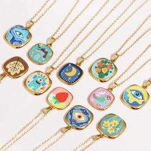 Flat lay of retro gold necklaces with various colorful enamel evil eye pendants