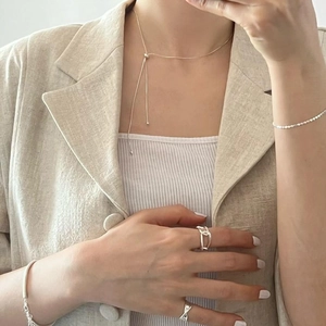 Close-up of minimalist 925 sterling silver snake chain necklace and adjustable ring