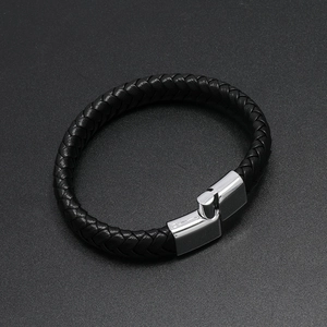 Detailed view of black braided leather texture and silver magnetic metal clasp