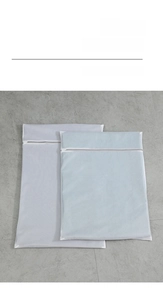 Close-up of thick mesh polyester laundry bags with gray zipper in two sizes