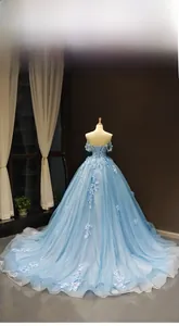 Detail of light blue off-shoulder gown featuring 3D floral lace and lace-up back closure