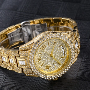 Detailed macro view of gold-tone iced out watch dial featuring day-date calendar display